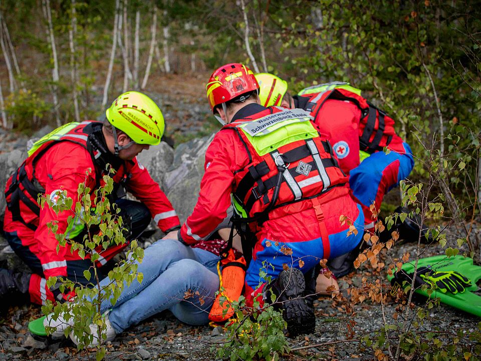 Retter der Wasserwacht versorgen eine Patientin